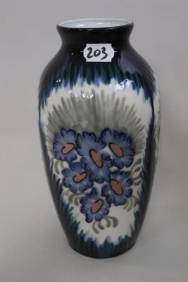 a blue and white vase with flowers on it