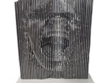 an image of a sculpture of a man ' s face made out of metal strips