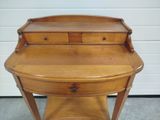 a small wooden desk with a drawer on it