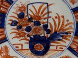 a decorative plate with an orange and blue design on it