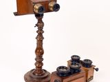 an old fashioned wooden camera and a wooden stand