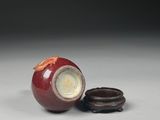 a red apple and a cookie sitting on a table