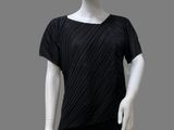 a white mannequin wearing a black top and black leggings
