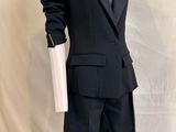 a mannequin wearing a black suit and tie on a mannequin