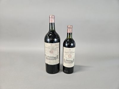 two bottles of wine sitting next to each other on a table