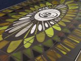 a stained glass table with a skull and flower design on it