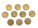 a close up of a bunch of gold coins on a white surface