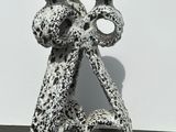 a black and white photo of two candlestick holders on a table
