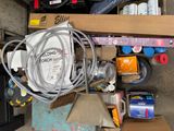 a pile of assorted items on a shelf in a garage
