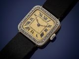 a close up of a wrist watch with roman numerals on it