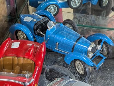 many toy cars that are on display in a glass case