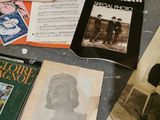 several old books are sitting on a table next to an old microphone