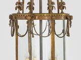 an image of a large brass hanging lantern with candles inside