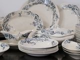 a lot of plates and bowls on the table