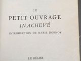 an old book with a black and white cover on a table
