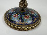 a blue and gold box with a flower design on it