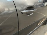 a close up of a car door handle on the side of the road