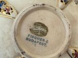 a white bowl with gold and blue decorations on it
