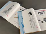 two open books on a table with a drawing of a woman