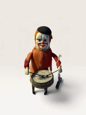 a toy figure of a clown with a drum