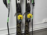 pair of skis and poles leaning against a wall in a room