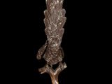 an image of a silver statue of a bird on top of a tree