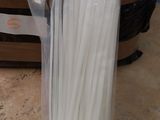 a package of white plastic straws in a plastic bag