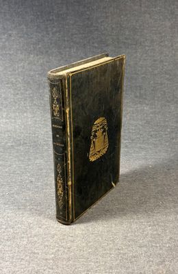 an old book sitting on top of a table next to a gray surface
