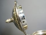 a close up of a silver plate with a clock on it