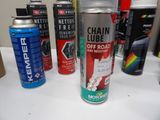 many different types of spray paint sitting on a table