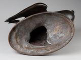 sculpture of a bird sitting on top of a metal object