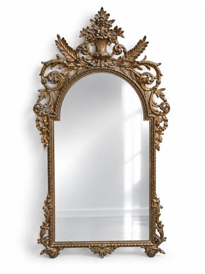 a large ornate gold mirror with a decorative frame