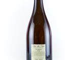 an empty bottle of wine sitting on top of a white surface