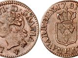 an old coin with a crown on top of it