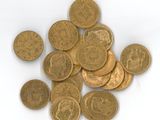 a pile of gold coins on a white surface