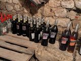 many bottles of wine and a pair of scissors on the table