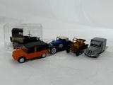 several toy cars are lined up in a row on a white surface