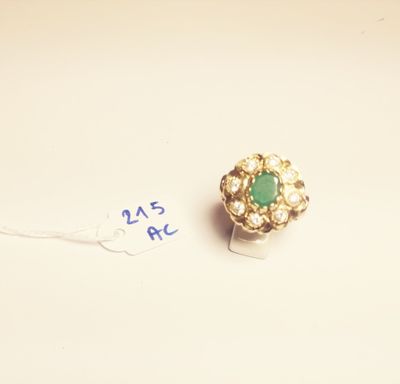 an image of a gold ring with a green stone surrounded by pearls