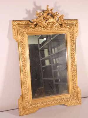 a mirror that is sitting on a shelf in a room