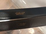 pair of black leather belt with gold plated logo on it