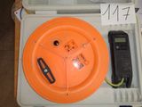 an orange lid on a white box with a phone in it