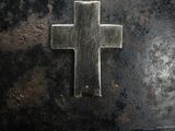 a metal helmet with a cross on it