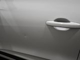 a white car with a door handle on it ' s side