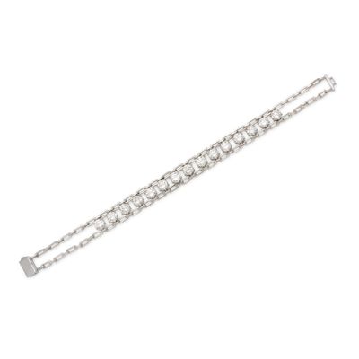 a close up of a diamond bracelet on a white background