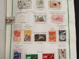 an open book with stamps on it on a table