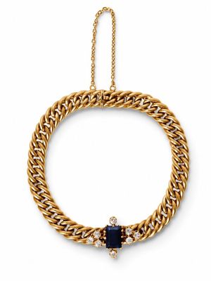 a gold chain bracelet with a sapphire stone and diamond clasp