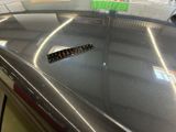 a sticker on the hood of a car in a garage