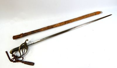 an old pair of swords with a wooden handle on a white surface