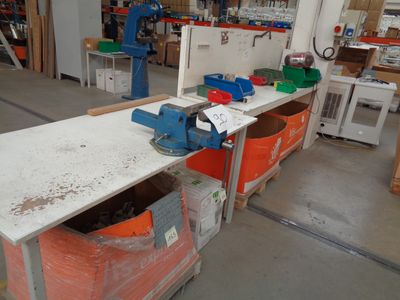 a workbench in the middle of a room with a lot of tools on it