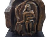sculpture of a woman sitting on a rock with a dog